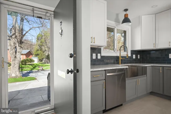 a kitchen with stainless steel appliances a refrigerator sink and stove