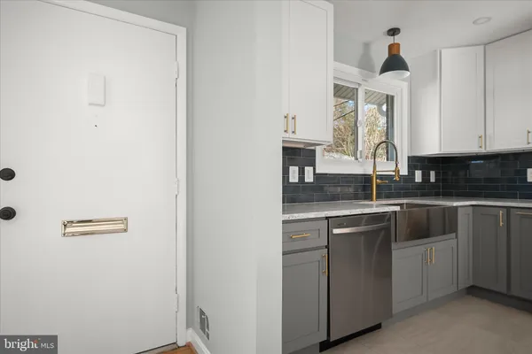 a kitchen with cabinets appliances a sink and a window