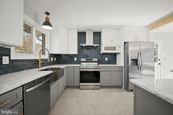 a kitchen with stainless steel appliances granite countertop a sink and cabinets