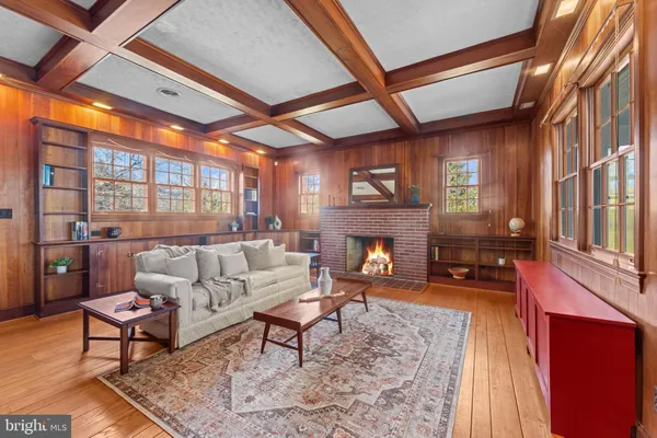 a living room with furniture a fireplace and a large window
