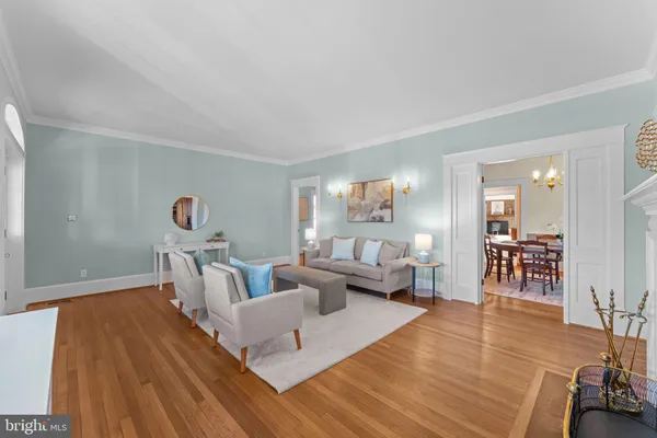 a view of an empty room with a large window with kitchen view