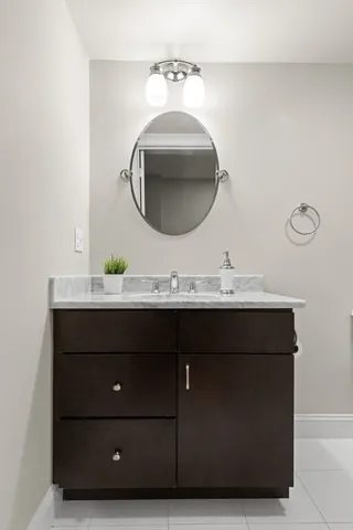a bathroom with a sink vanity and a mirror