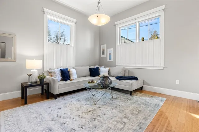a living room with furniture and a painting on the wall