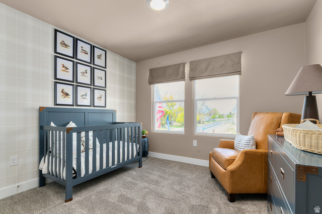 2819 South 710th West, Unit 14 Logan, UT 84321 - Photo 24 of 24 Neutral-toned room featuring a patterned accent wall and two windows with fabric window treatments