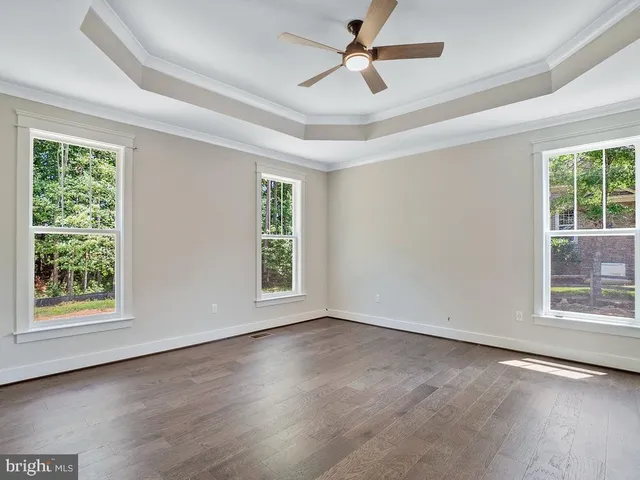 a large kitchen with white cabinets and stainless steel appliances