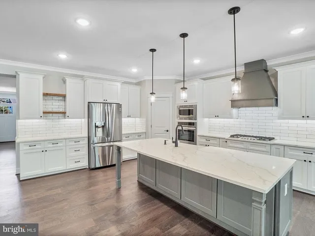 a view of empty room with wooden floor and fireplace