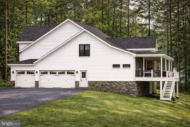 a kitchen with stainless steel appliances kitchen island a sink and a refrigerator