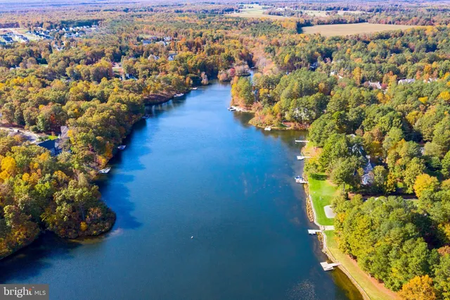 a kitchen with a stove a sink and a wooden floor