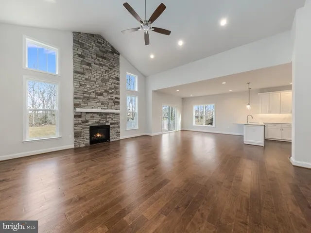 a kitchen with stainless steel appliances a sink a stove a refrigerator and cabinets