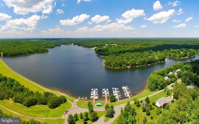 a view of a backyard with swimming pool and seating
