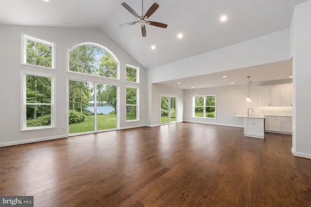 a kitchen with a sink a refrigerator and cabinets