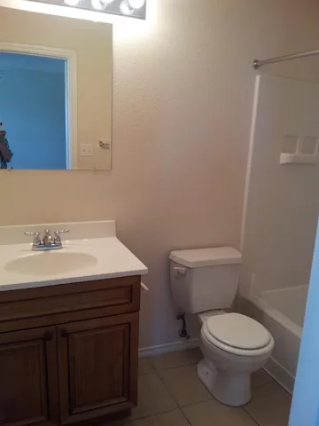 a bathroom with a sink a toilet and a mirror