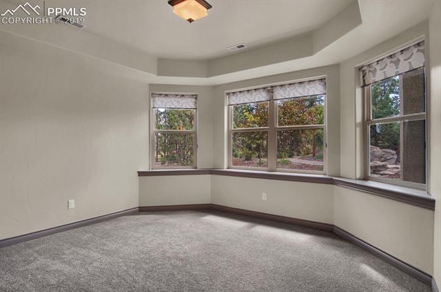 12710 Myrick Road Colorado Springs, CO 80908 - Photo 7 of 10 Lower level BR with views to water feature