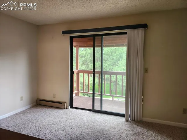 a view of empty room with floor to ceiling window