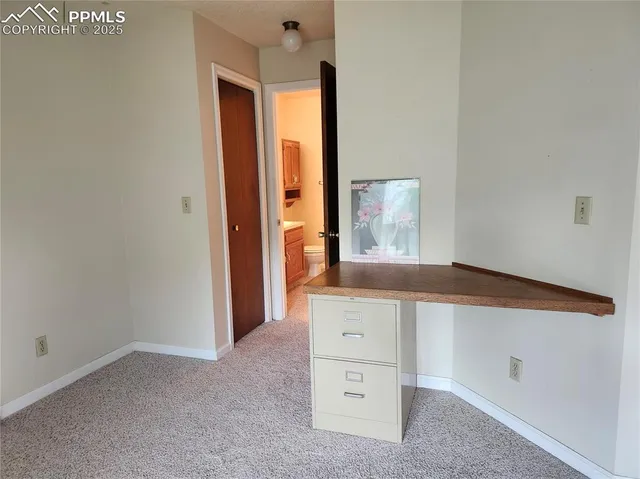 a bathroom with a granite countertop toilet sink and mirror