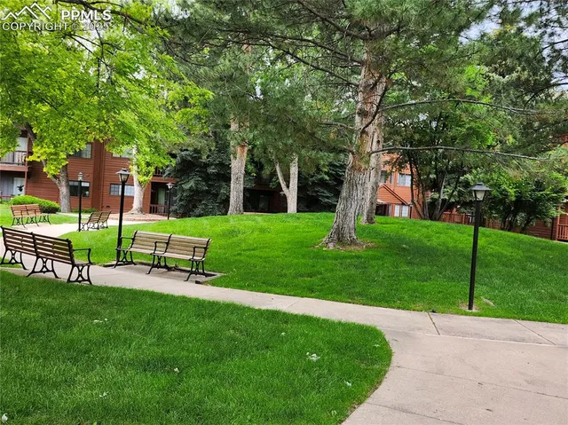 a view of a patio with couches table and chairs and potted plants