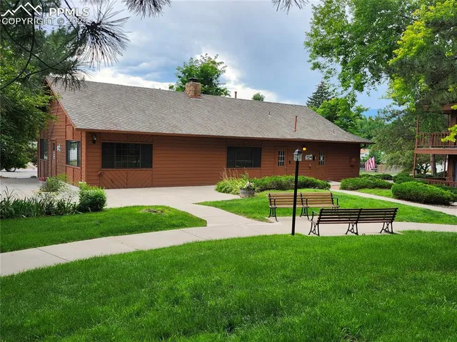 a view of a porch with wooden floor and iron stairs