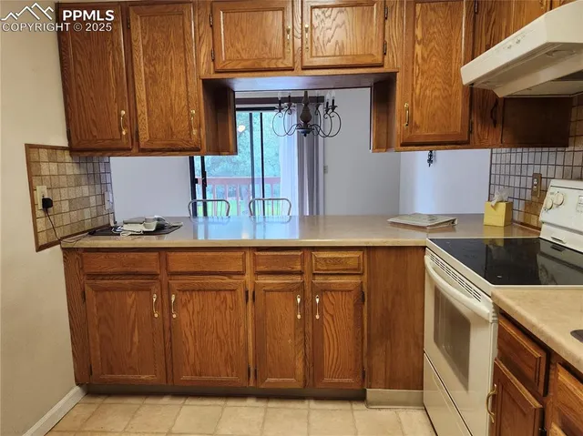a kitchen with stainless steel appliances granite countertop a sink and cabinets