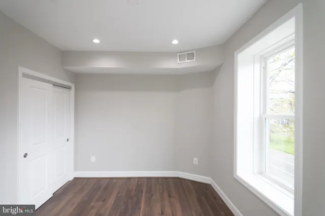 a view of room with window and wooden floor