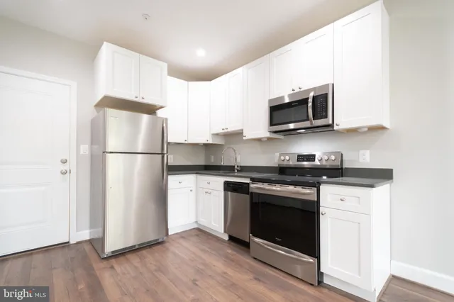 a kitchen with stainless steel appliances a refrigerator stove and microwave