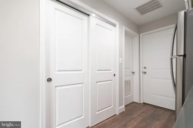 a view of a room with wooden floor