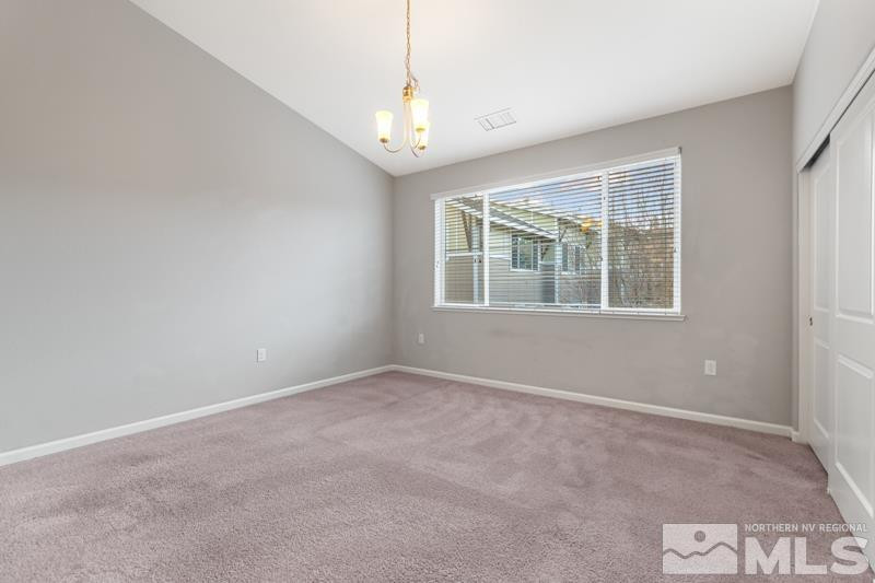 285 Mark Jeffrey Lane Reno, NV 89503 - Photo 12 of 16 an empty room with windows and chandelier