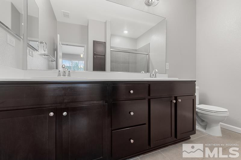 285 Mark Jeffrey Lane Reno, NV 89503 - Photo 13 of 16 a bathroom with a sink vanity and toilet