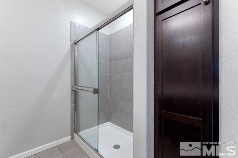 285 Mark Jeffrey Lane Reno, NV 89503 - Photo 14 of 16 a bathroom with a glass shower door