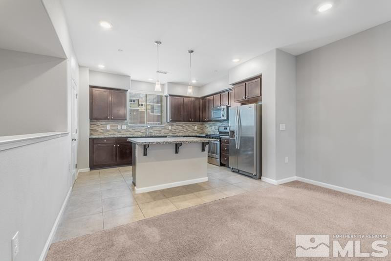 285 Mark Jeffrey Lane Reno, NV 89503 - Photo 2 of 16 a large kitchen with stainless steel appliances kitchen island granite countertop a refrigerator and a sink