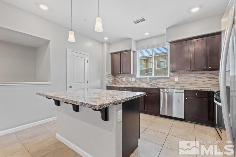 285 Mark Jeffrey Lane Reno, NV 89503 - Photo 3 of 16 a kitchen with a sink stove and cabinets