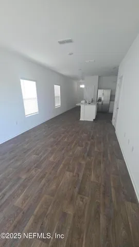 a view of a big room with closet and windows