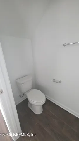 a white toilet sitting next to a white sink