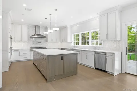 a kitchen with granite countertop white cabinets and white appliances