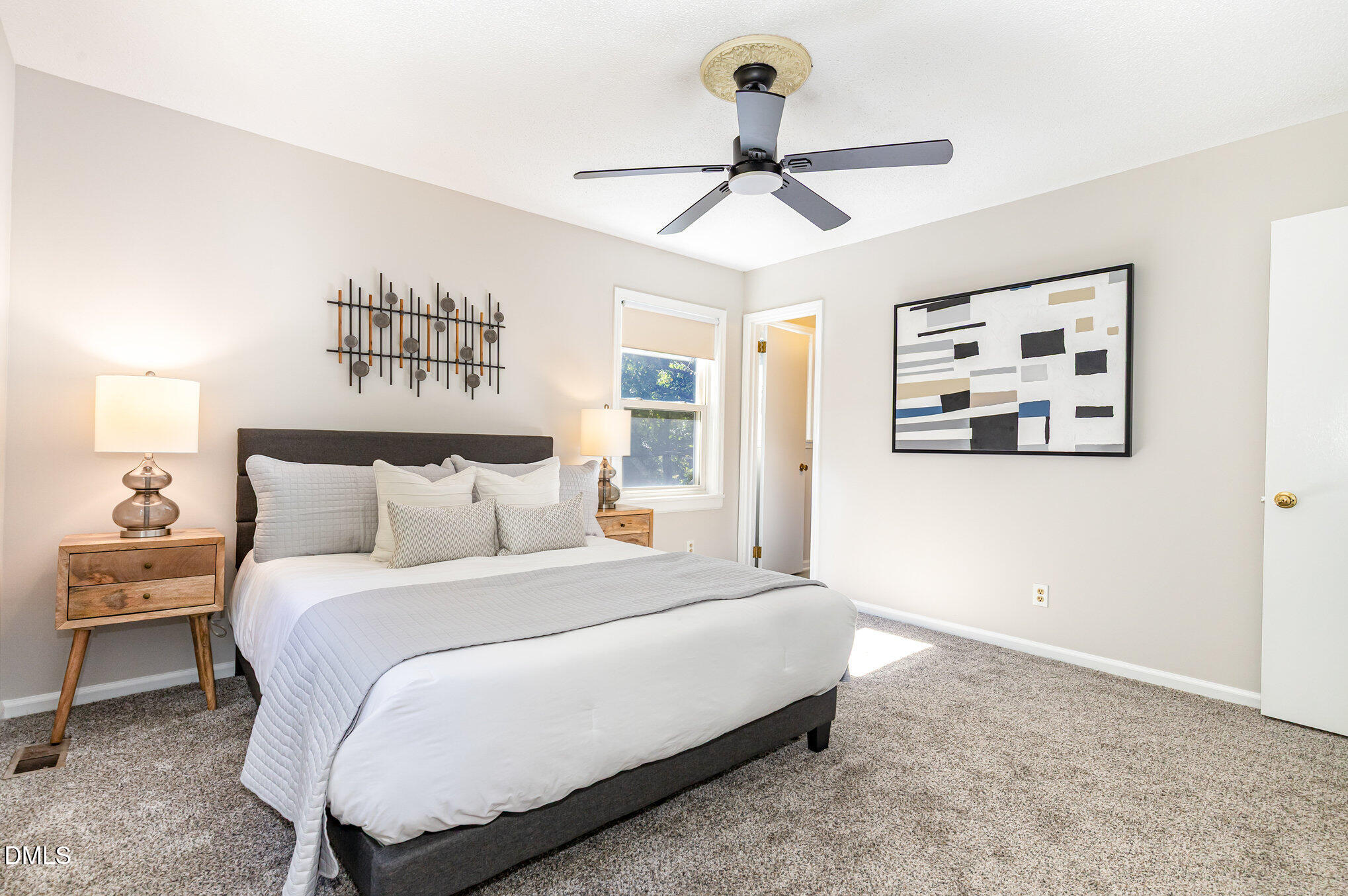 1316 Dixie Trail Raleigh, NC 27607 - Photo 14 of 36 a bedroom with a bed and a chandelier