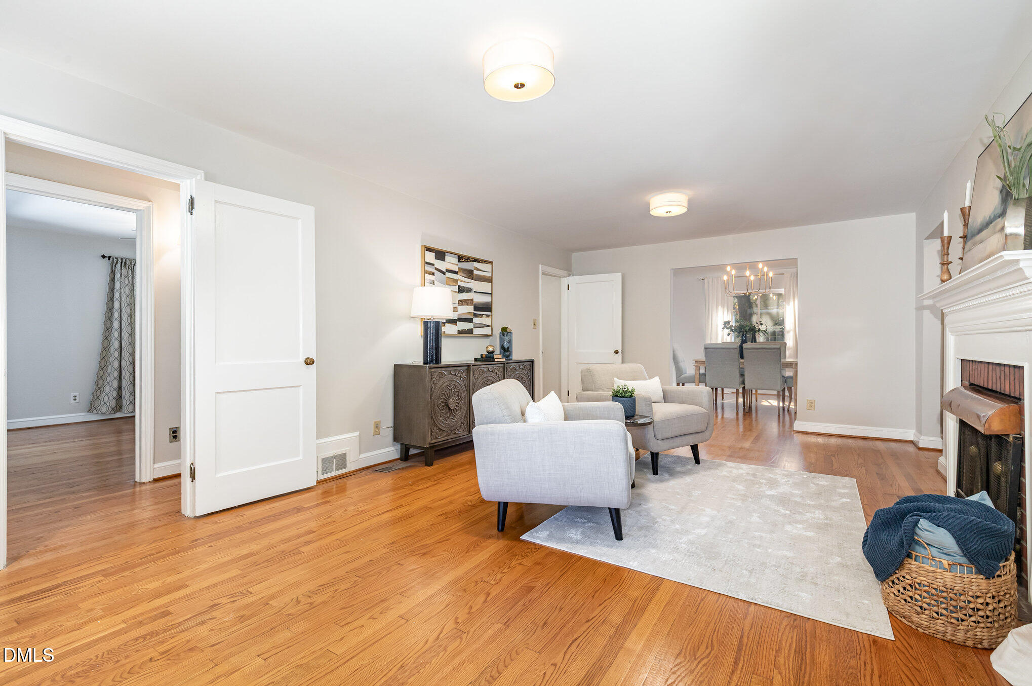1316 Dixie Trail Raleigh, NC 27607 - Photo 6 of 36 a living room with fireplace furniture and a wooden floor
