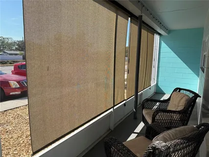 a couple of chairs sitting in balcony with outdoor seating