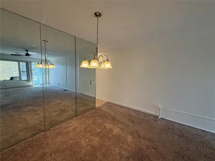 a view of a room with a ceiling fan