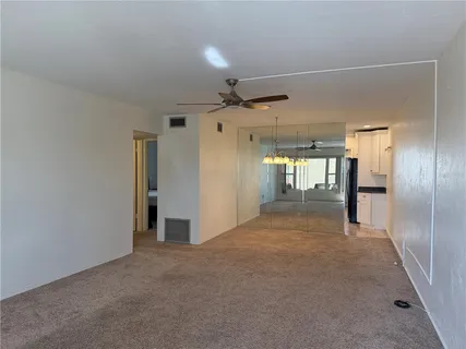 a view of empty room with a ceiling fan