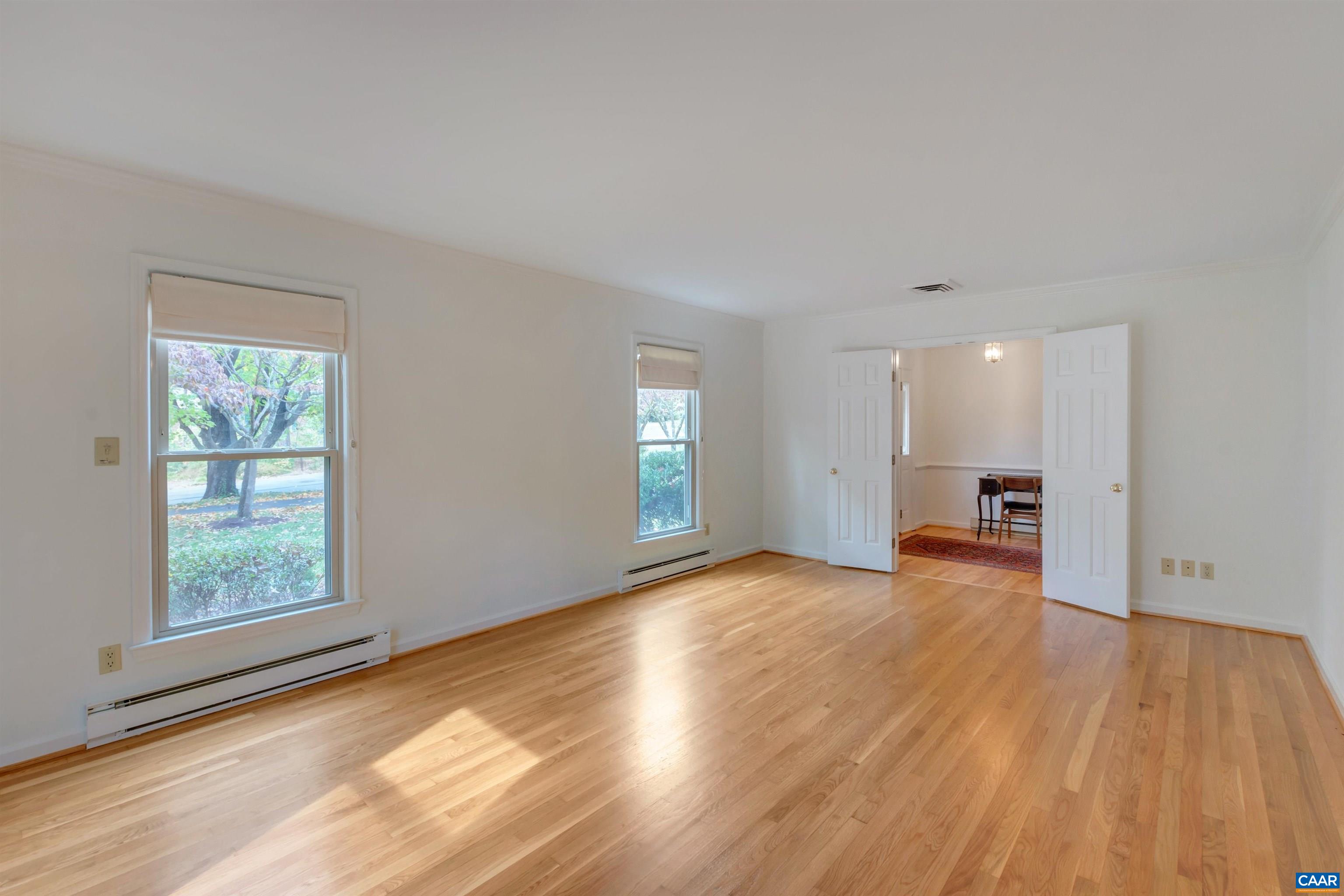 208 Westminster Road Charlottesville, VA 22901 - Photo 7 of 38 an empty room with wooden floor and windows