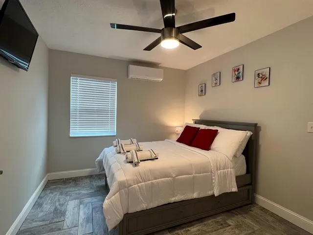 a bedroom with a bed and a flat screen tv