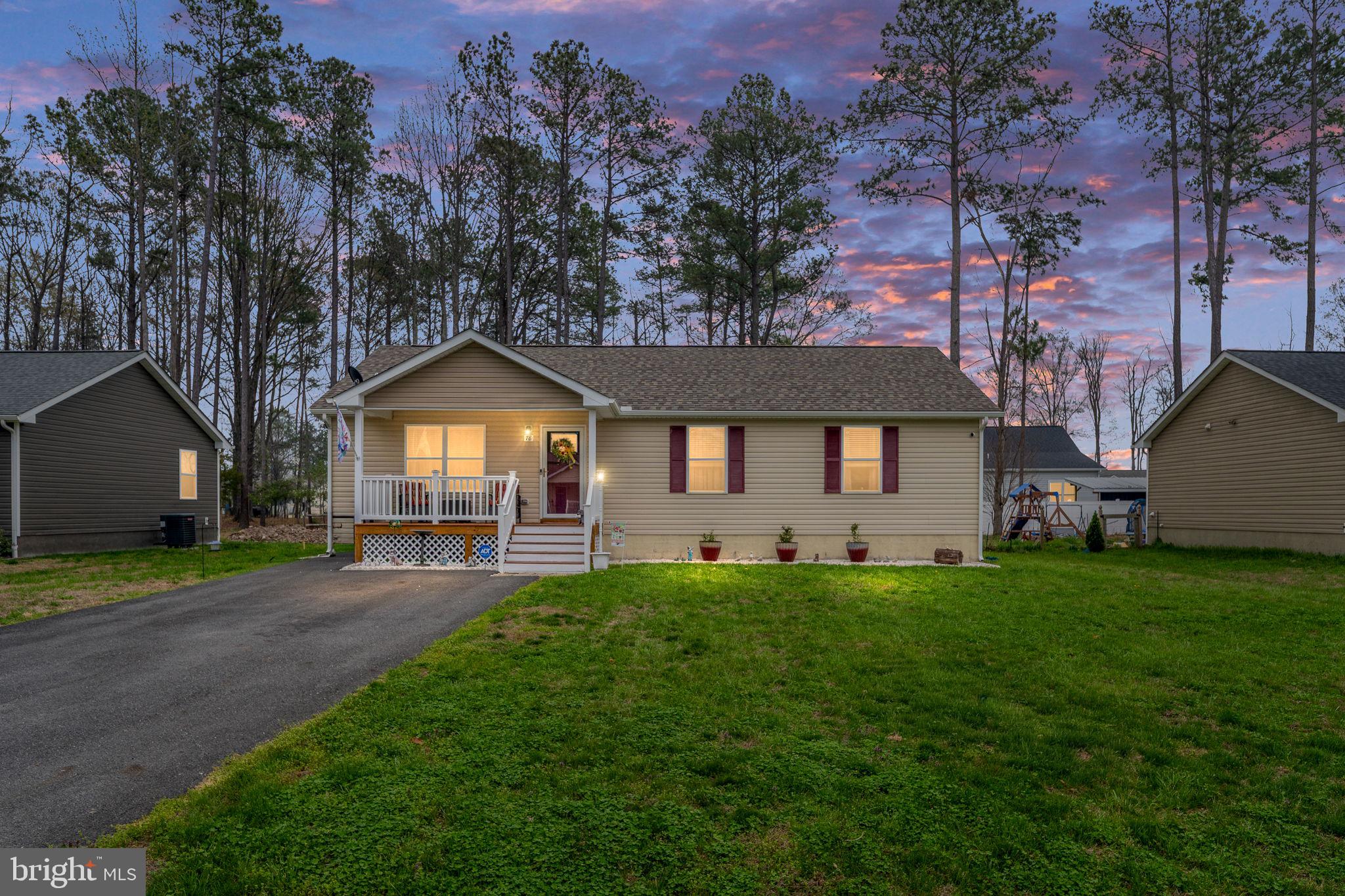 Charming home at dusk, nature's backdrop.