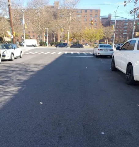 a view of a city street with a cars park