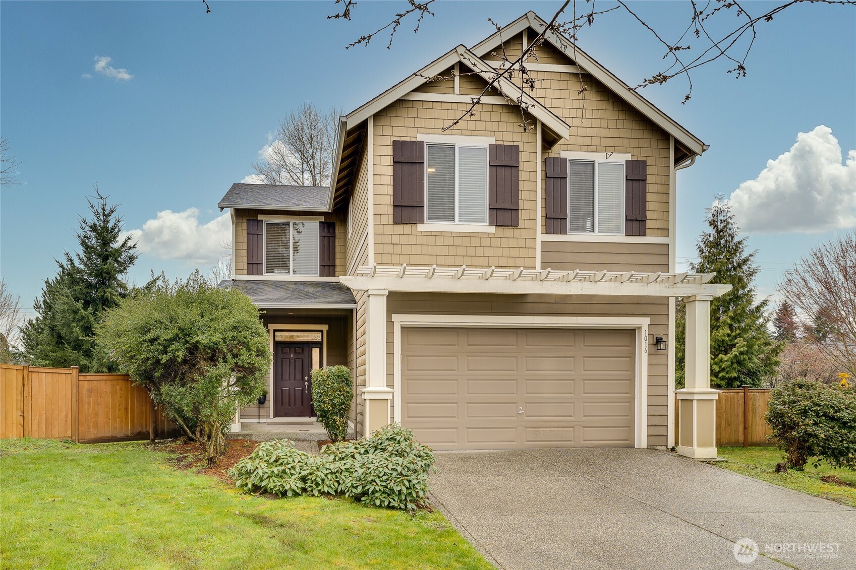 1016 207th Street Southwest Lynnwood, WA 98036 - Photo 1 of 39 a front view of a house with a yard and garage