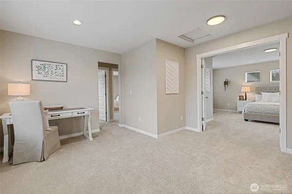 a spacious bedroom with a bed and a couch