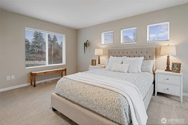 a bedroom with a large bed and a window