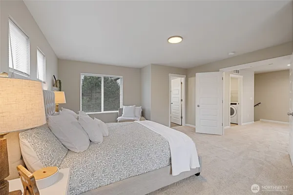 a bathroom with a tub a sink and a large mirror