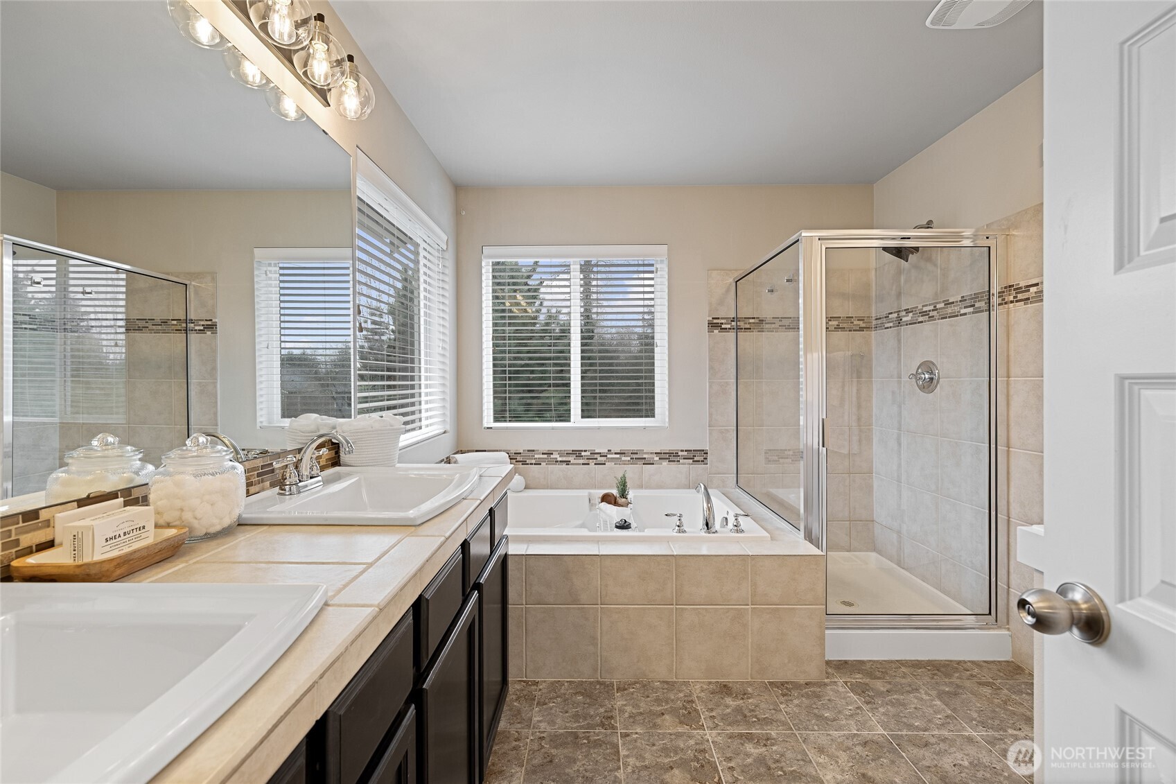 1016 207th Street Southwest Lynnwood, WA 98036 - Photo 20 of 39 a bathroom with a tub a sink and a large mirror