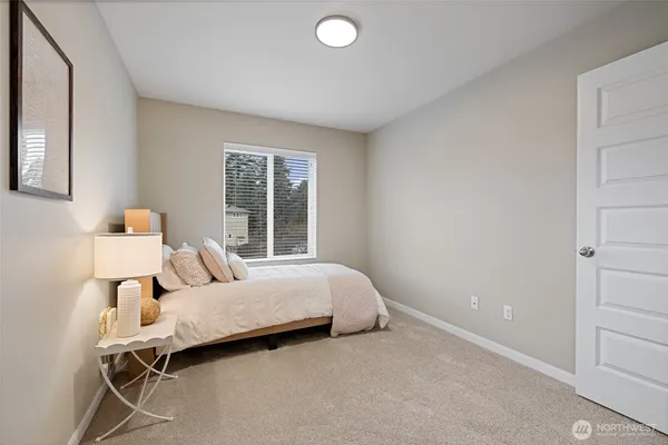 a bathroom with a granite countertop sink toilet and mirror