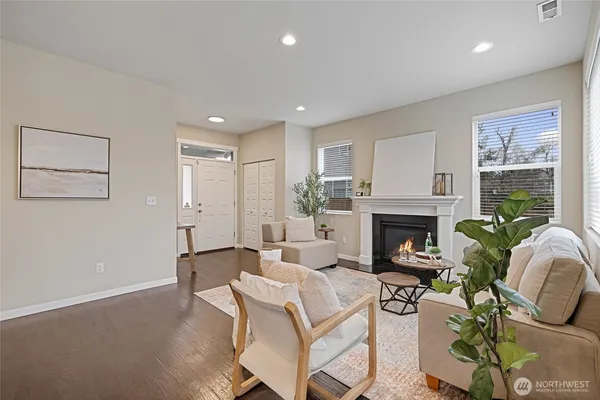 a living room with furniture and a kitchen area