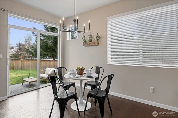 a kitchen with kitchen island a stove a table and chairs in it